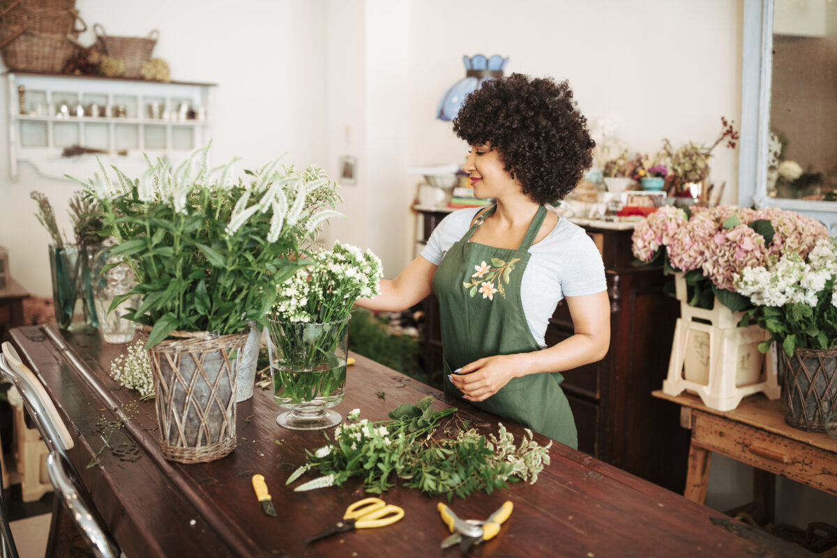 Florist arranging flowers using professional floral arrangement supplies
