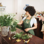 Florist arranging flowers using professional floral arrangement supplies